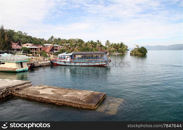 Ferry boat near pier Tuk-tuk on Samosir island, Indonesia