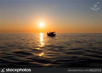 Ferry boat silhouette with people passengers at sunset sun in mediterranean sea