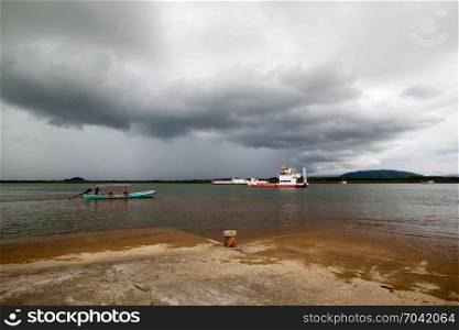 ferry boat under rainstrom cloud in Ko Kho Khao, Phang Nga Thailand