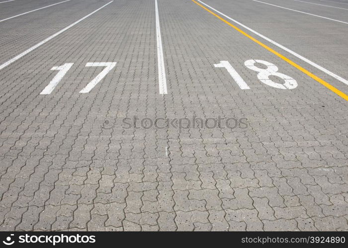 Ferry lane number17 and 18. Ferry lane number 17 and 18 painted white on paving stone