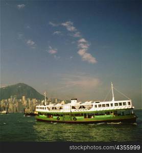 Ferry near a harbor, Victoria Harbor, Hong Kong, China