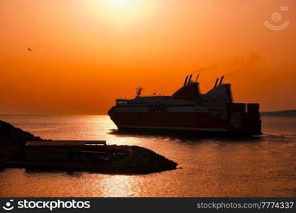 Ferry vessel in sea departing port of Marseille for Corsica on sunset. Marseille, France. Ferry vessel departing port of Marseille for Corsica