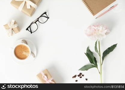 Festive arrangement  gift boxes, coffee, notebook, mobile phone, glasses and flowers on a white table, top view, flat lay