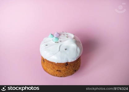 Festive cake in white glaze with decorations on a pink background. Festive cake in white glaze