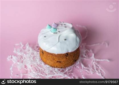 Festive cake in white glaze with decorations on a pink background. Festive cake in white glaze