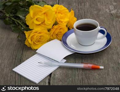 festive card, yellow roses, notebook and coffee, still life on a subject flowers and drinks
