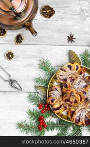 Festive Christmas cookies baking. Homemade cookies on plate decorated with fir branches