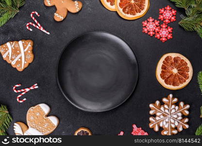 Festive Christmas table with appliances, gingerbreads, tree branches and dried citrus trees. Preparations for the celebration. Festive Christmas table with appliances, gingerbreads, tree branches and dried citrus trees