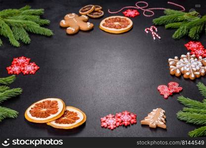 Festive Christmas table with appliances, gingerbreads, tree branches and dried citrus trees. Preparations for the celebration. Festive Christmas table with appliances, gingerbreads, tree branches and dried citrus trees