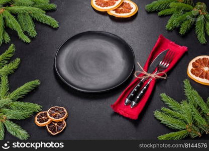 Festive Christmas table with appliances, gingerbreads, tree branches and dried citrus trees. Preparations for the celebration. Festive Christmas table with appliances, gingerbreads, tree branches and dried citrus trees