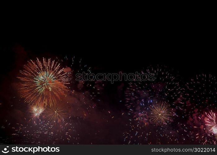Festive colour firework background at a dark night