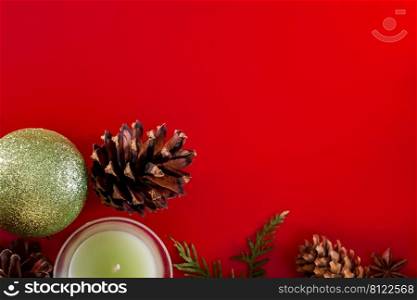 Festive composition of co≠s and Christmas balls on a red background for design and greeting cards. Place for text.. Festive composition of co≠s and Christmas balls on a red background for design and greeting cards.