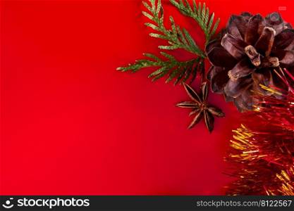 Festive composition of cones and Christmas balls on a red background for design and greeting cards. Place for text.. Festive composition of cones and Christmas balls on a red background for design and greeting cards.