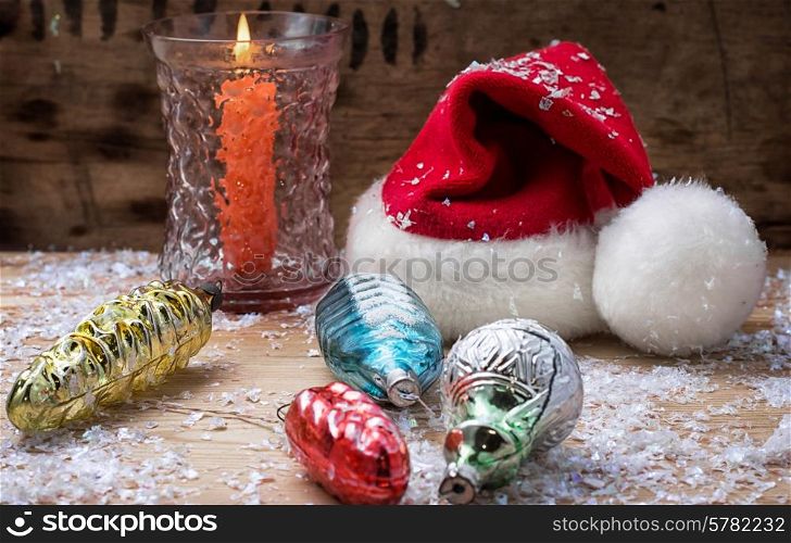 festive decoration with Christmas hat and a burning candle