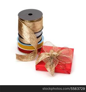Festive gift box and wrapping ribbons isolated on white background