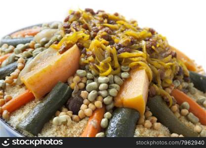 Festive Moroccan couscous with onions and raisins on a dish close up