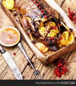 Festive roast duck with orange and cranberries. Appetizing roasted duck with oranges cooked to a rustic recipe