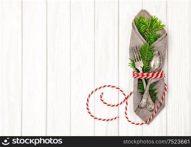 Festive table place setting decoration with christmas tree brunches