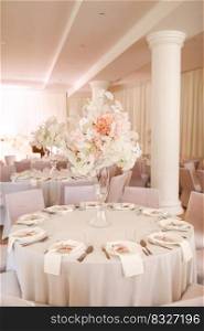 festive wedding decoration. Beautiful fresh white and pink flowers in glass vase on dining table on wedding day. High quality photo.. festive wedding decoration. Beautiful fresh white and pink flowers in glass vase on dining table on wedding day. High quality photo
