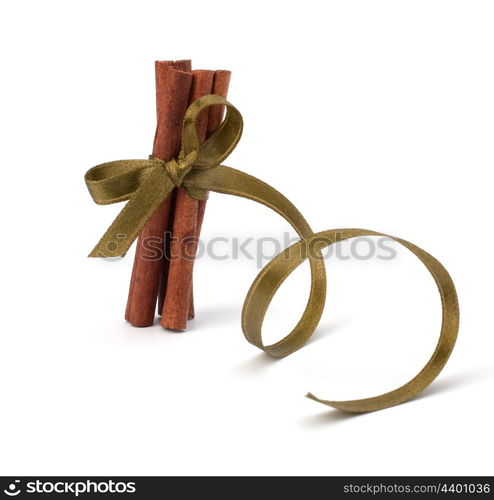 Festive wrapped cinnamon sticks isolated on white background