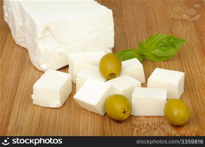 feta cheese and olives on a cutting board