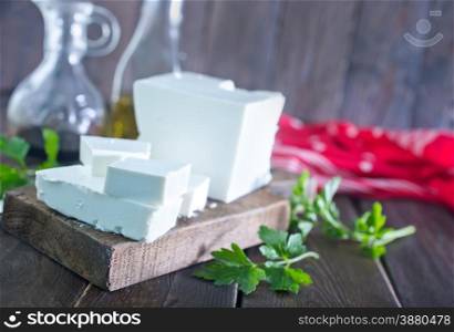 feta cheese on the wooden board and on a table
