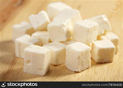 feta cheese on wooden cutting board
