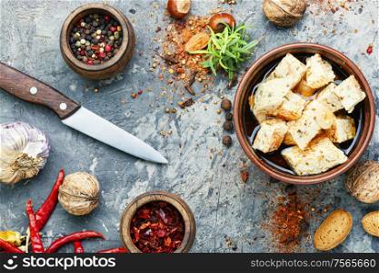 Feta cheese with herbs and garlic in bowl. Homemade feta cheese with herbs