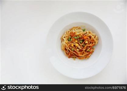 Fettuccine pasta in tomato sauce isolated in white background
