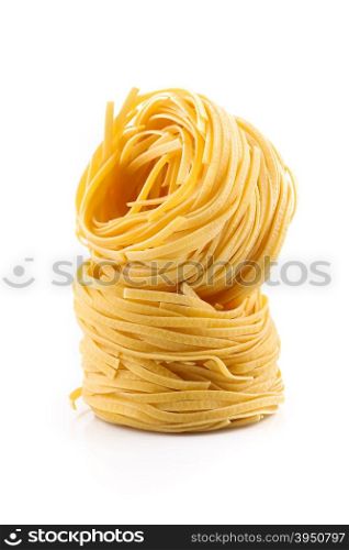 Fettuccine pasta nest isolated on white background