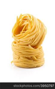 Fettuccine pasta nest isolated on white background