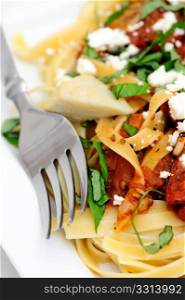 Fettuccini With Roasted Tomato And Basil. Fettuccini topped with tomatoes roasted in olive oil and italian herbs and spices with marinated artichoke hearts sliced fresh basil and feta cheese