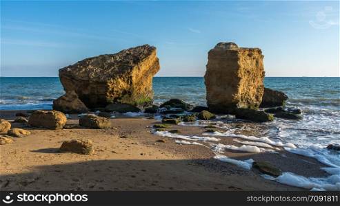 Few limestone stones on a Sunny autumn day on the seashore near the village of Fontanka, Odessa region, Ukraine. Several huge limestone stones by the sea