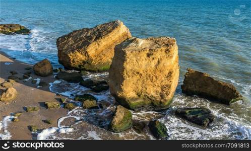 Few limestone stones on a Sunny autumn day on the seashore near the village of Fontanka, Odessa region, Ukraine. Several huge limestone stones by the sea