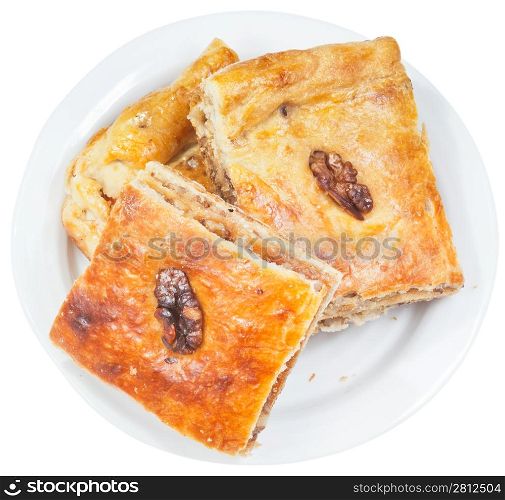few pieces of pakhlava sweet dessert with walnut on plate isolated on white background