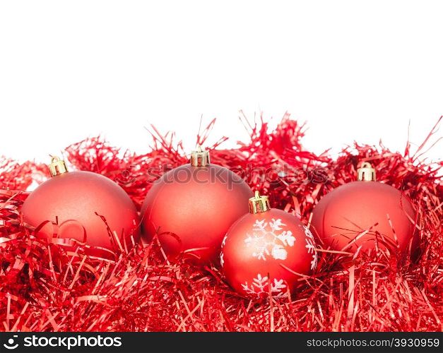 few red Xtmas baubles and tinsel isolated on white background