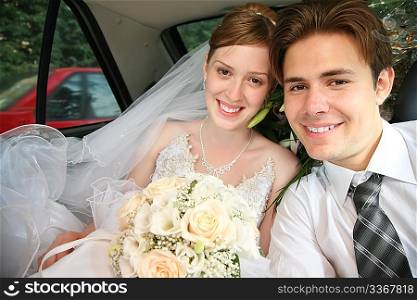 fiance and bride sit in the automobile