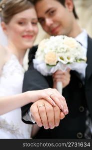 fiance with the bride, shows the rings