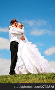 fiance with the bride they are embraced on to the meadow