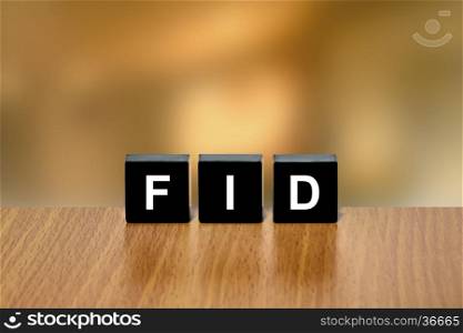 FID or final investment decision on black block with blurred background