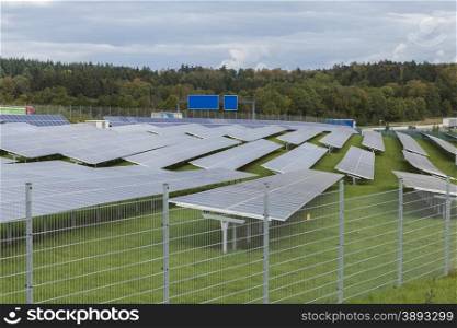 Field with blue siliciom solar cells alternative energy. Field with blue siliciom solar cells alternative energy to collect sun energy