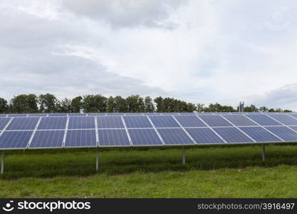 Field with blue siliciom solar cells alternative energy. Field with blue siliciom solar cells alternative energy to collect sun energy