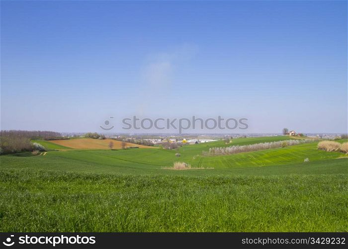 Fields, with little city on the background