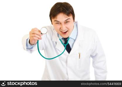 Fierce medical doctor holding up stethoscope isolated on white&#xA;