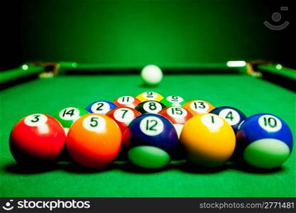 Fifteen billiard spheres lay on green cloth
