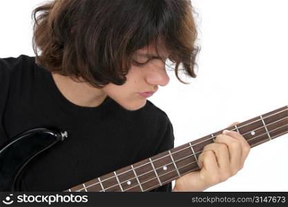 Fifteen Year Old Teen Boy Playing Bass Guitar. Close crop, boy looking at fingering hand.