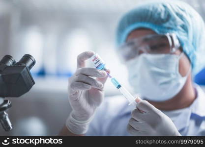 fight against COVID-19, coronavirus vaccine research in laboratory, professional scientists holds syringe and bottle vaccine for virus cure treatment injection, medicine clinical during pandemic