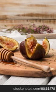 Figs and honey on a wooden table selective focus.