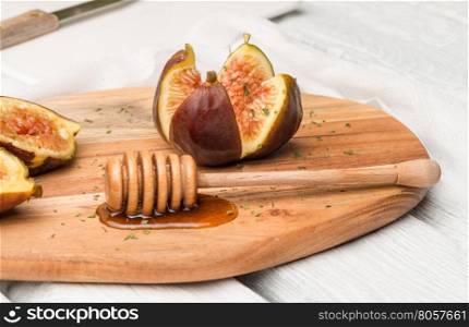 Figs and honey on a wooden table selective focus.