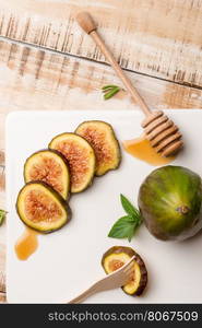 Figs and honey on a wooden table selective focus.